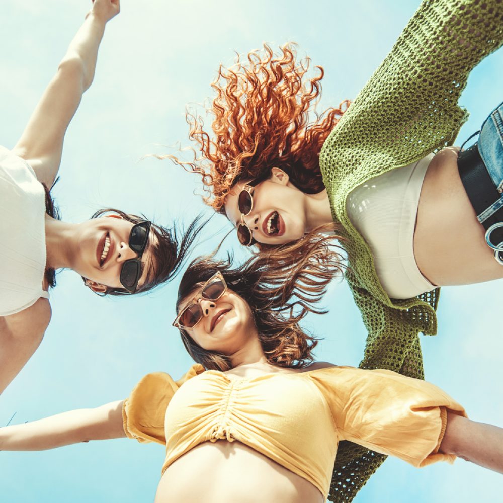 three girlfriends having fun with hands up three girlfriends having fun with hands up